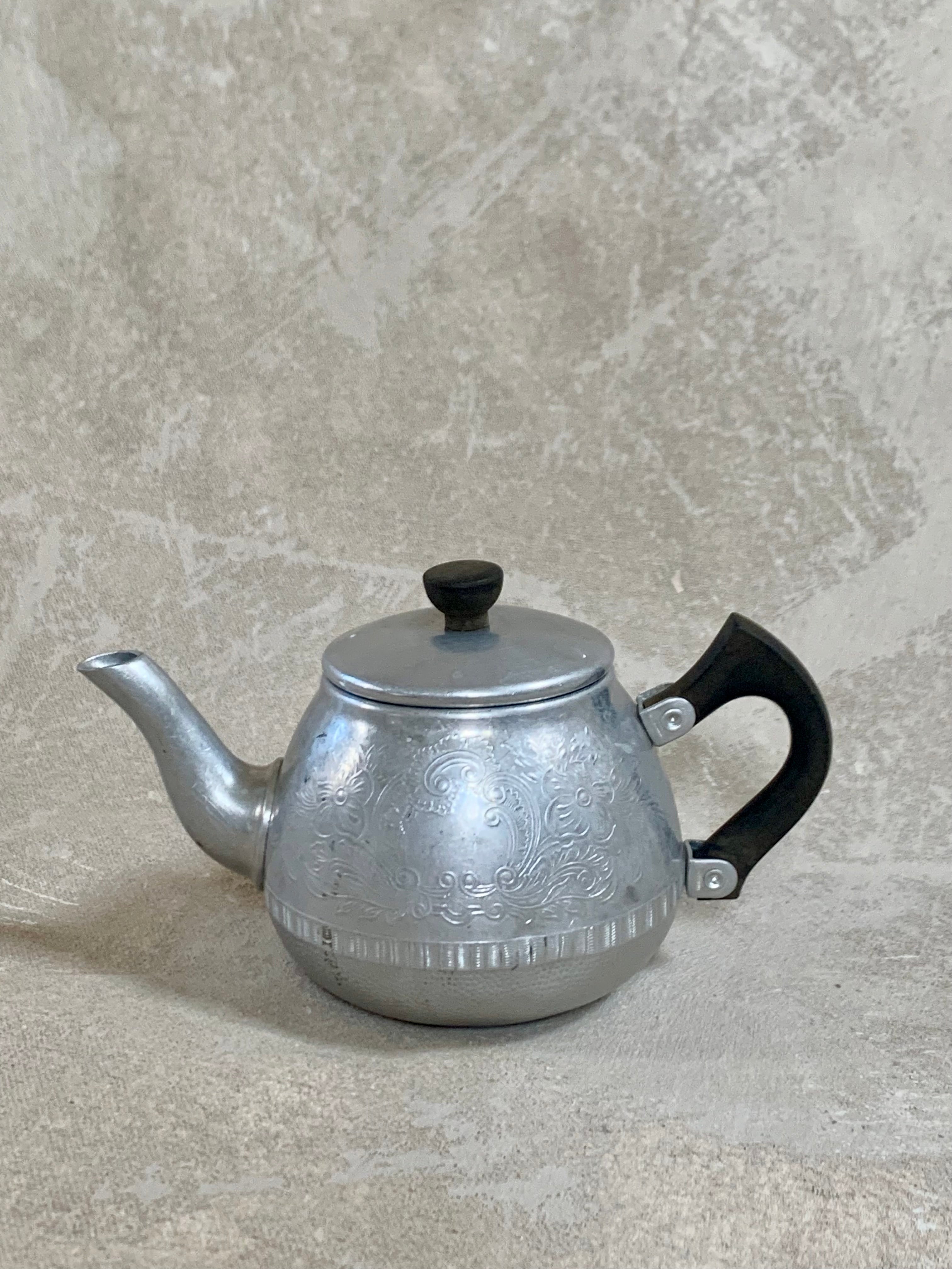 Lid and Bakelite finial of Carlton aluminum teapot, seated correctly — Swan Brand, Made in England, 1950s