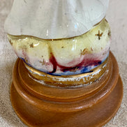 Three-quarter view of Mexican Fatima figurine showing mantle detail and gold borders — 1950s