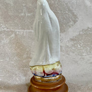 Side profile of Our Lady of Fatima ceramic figurine — white crackle glaze, gold scrollwork border
