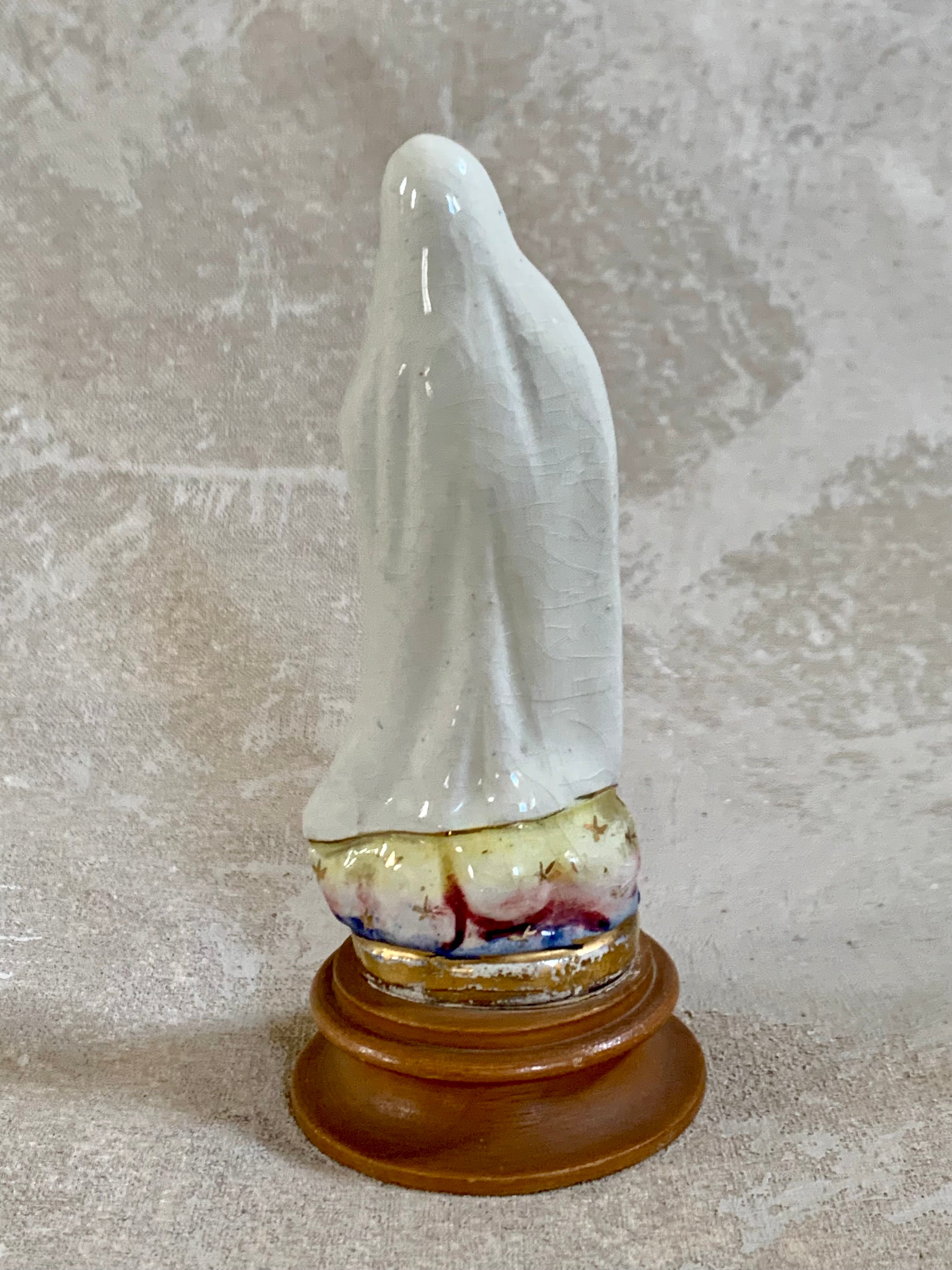 Side profile of Our Lady of Fatima ceramic figurine — white crackle glaze, gold scrollwork border