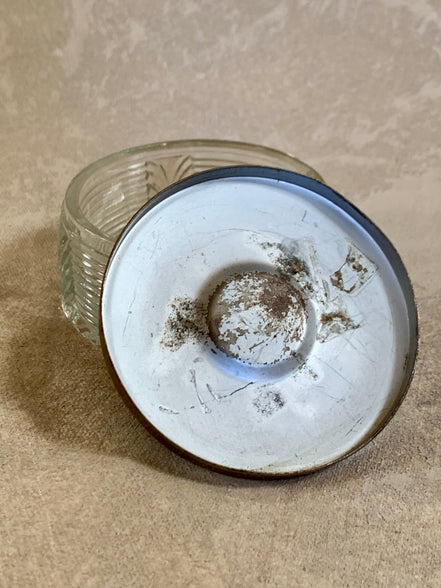 Enamel lid detail of Art Deco powder jar showing gilt cartouche and gold stripe — 1920s–1930s