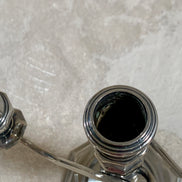 S-curve arm junction detail on silver plate candelabra — American silver plate, 1940s–1960s