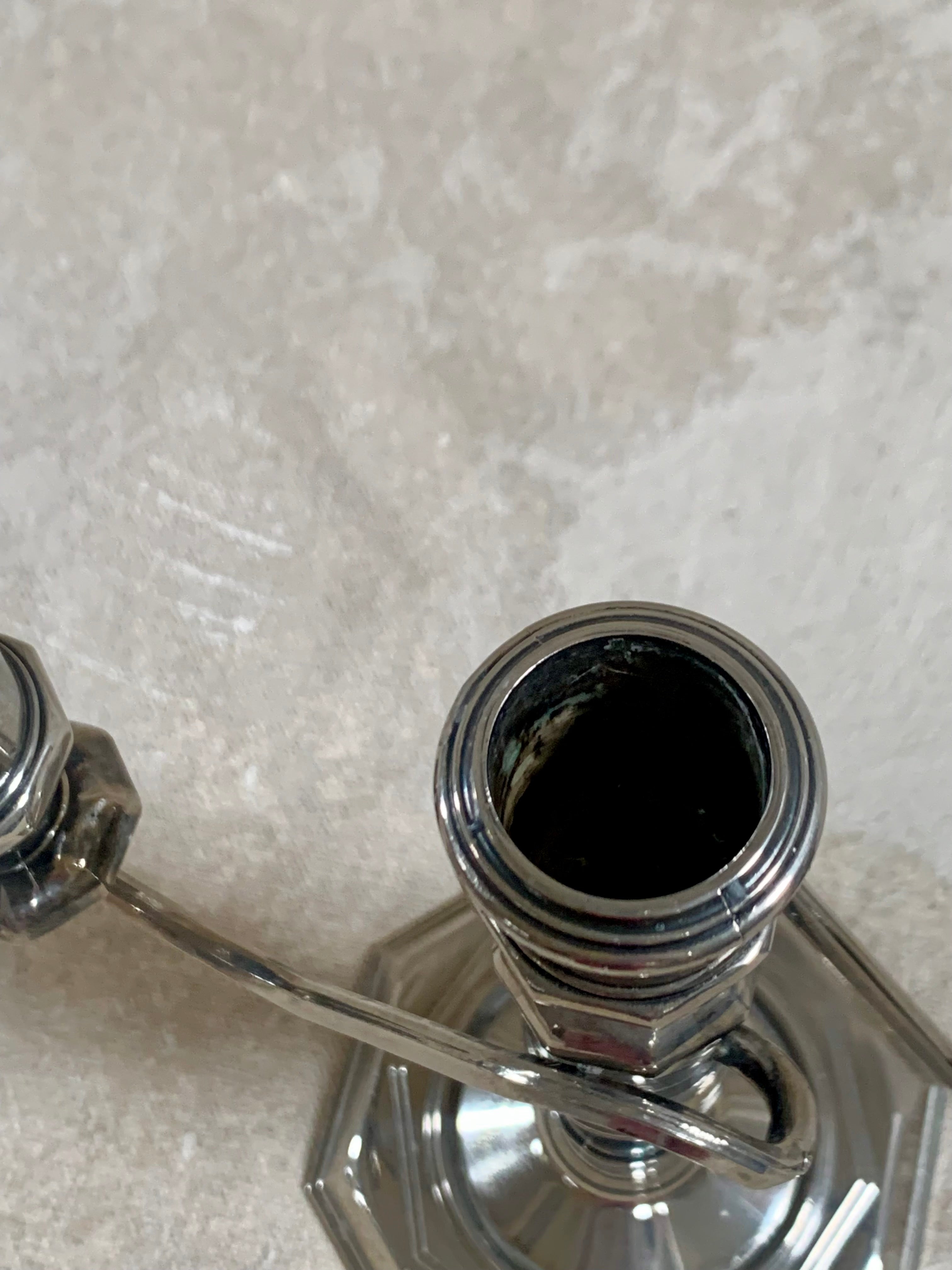 S-curve arm junction detail on silver plate candelabra — American silver plate, 1940s–1960s