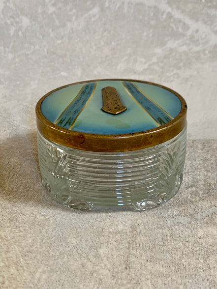 Gilt cartouche detail on powder blue enamel lid of Art Deco pressed glass jar — 1925–1935