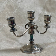Base detail of silver plate three-light candelabra showing octagonal stepped construction