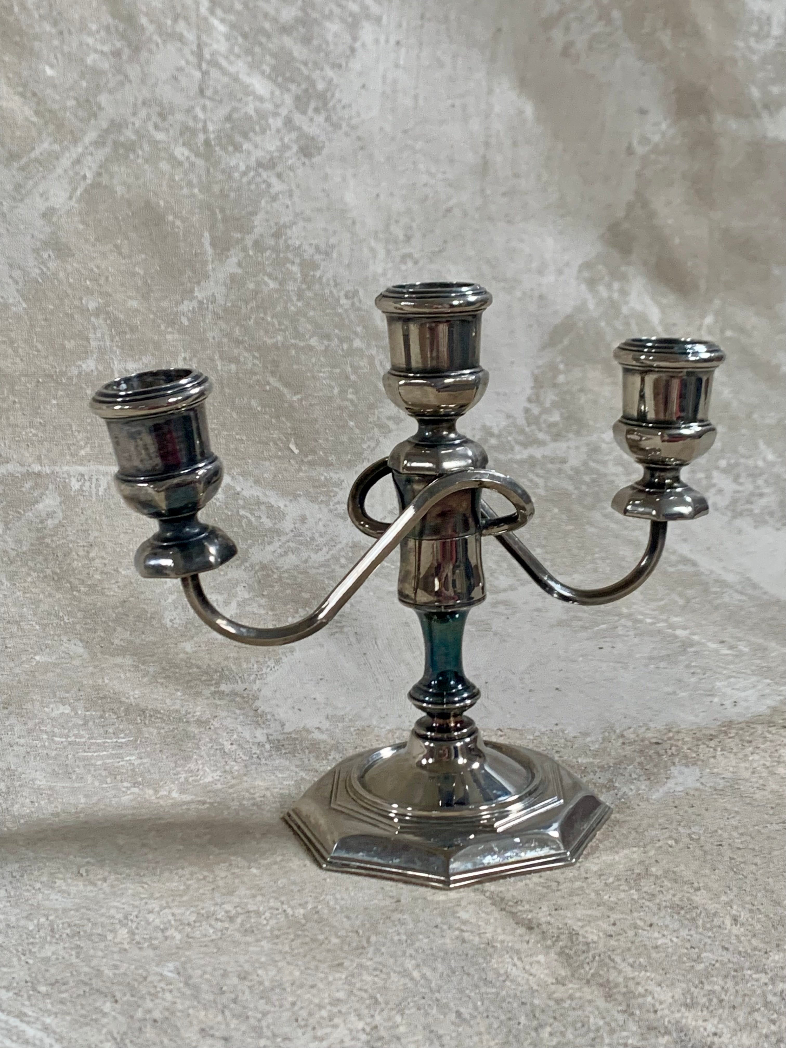 Base detail of silver plate three-light candelabra showing octagonal stepped construction