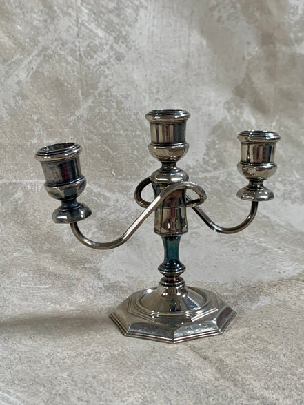 Base detail of silver plate three-light candelabra showing octagonal stepped construction