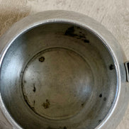 Three-quarter view of Carlton aluminum teapot showing full etched band and handle profile — Jolene Le Mille Archive