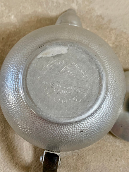 Stylized floral and acanthus engraving detail on Swan Brand Carlton aluminum body — hand-tooled, 1950s