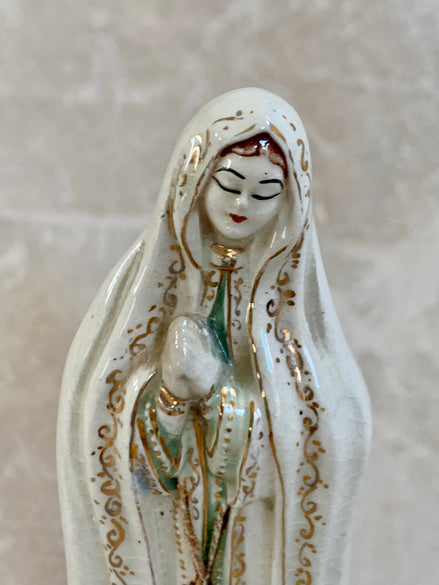 Front view of Our Lady of Fatima figurine showing blue-green robe and prayer hands — Jalisco Mexico