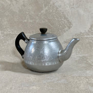 Side profile of Carlton aluminum teapot showing hand-etched acanthus and floral band — Made in England, Bulpitt & Sons, 1950s