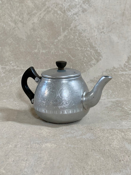 Side profile of Carlton aluminum teapot showing hand-etched acanthus and floral band — Made in England, Bulpitt & Sons, 1950s
